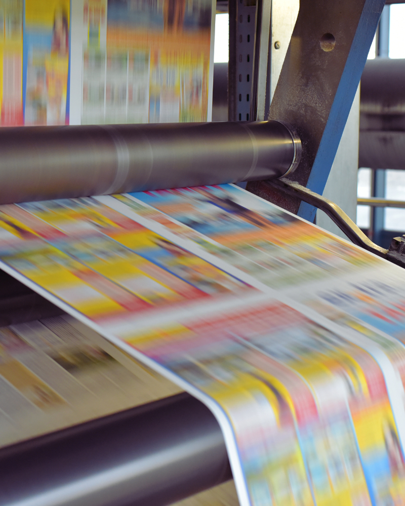 Industrial printer printing coloured paper products